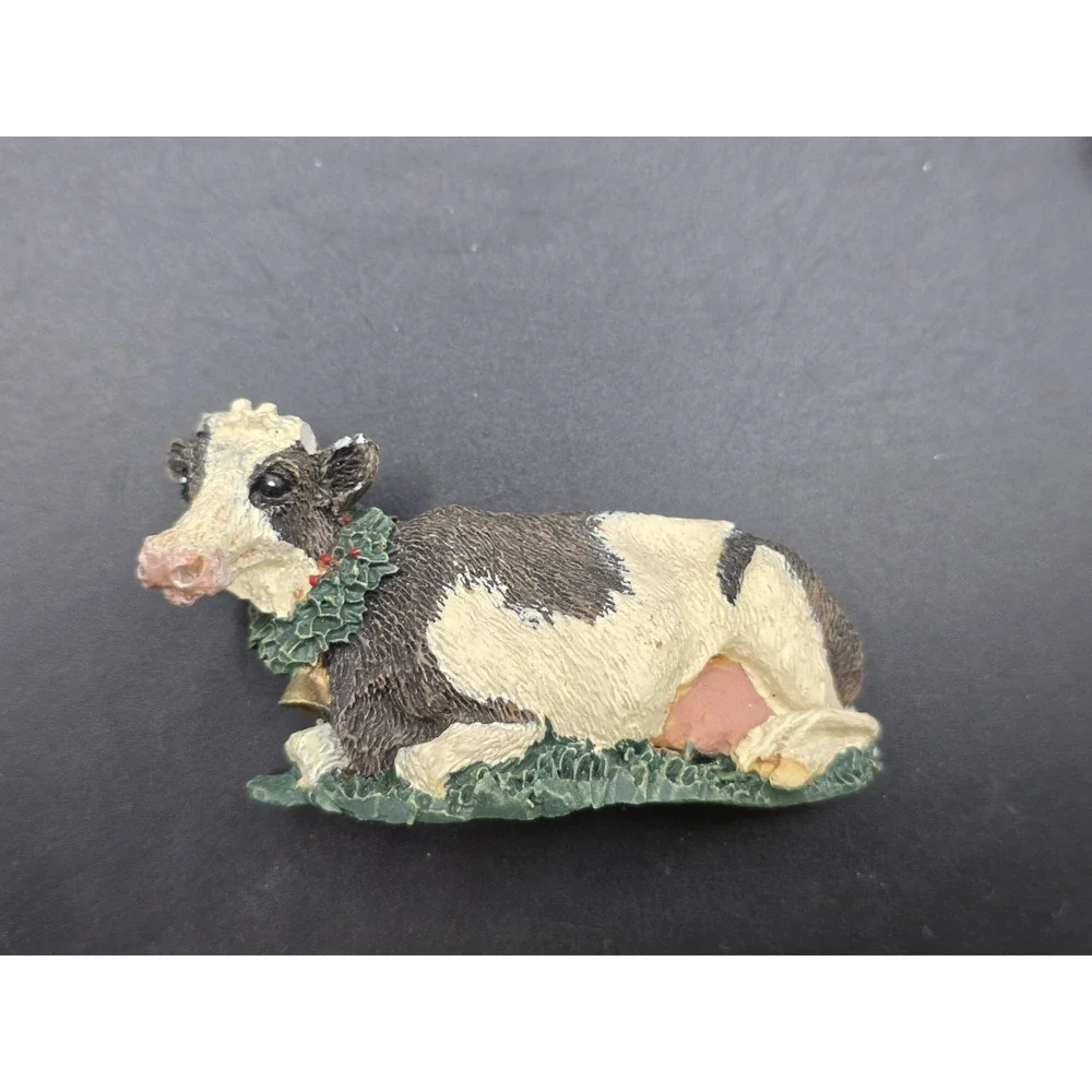 This collection features various vintage-style cow refrigerator magnets